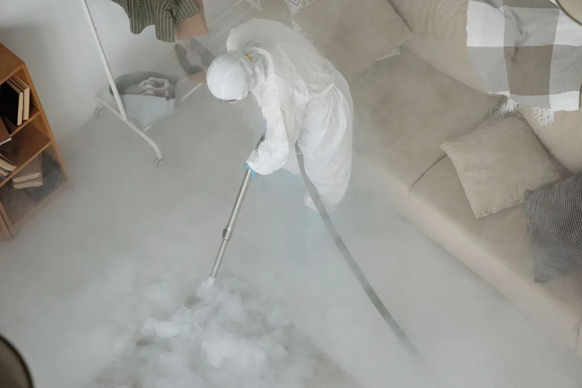 Biohazard cleanup technician in protective equipment, Nuevo, CA